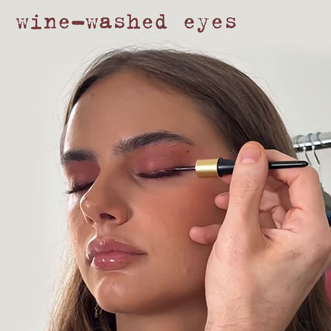 Makeup application with a brush on a neutral background