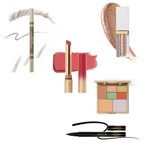 Collection of Stila make-up products including a lip pencil, lipstick, eye shadow palette, and eyeliner on a white background.