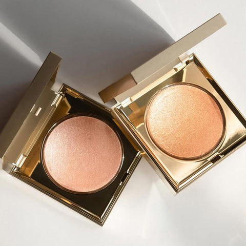 Two open Stila Heaven's Hue compact cases with pinkish-beige powders on a light background